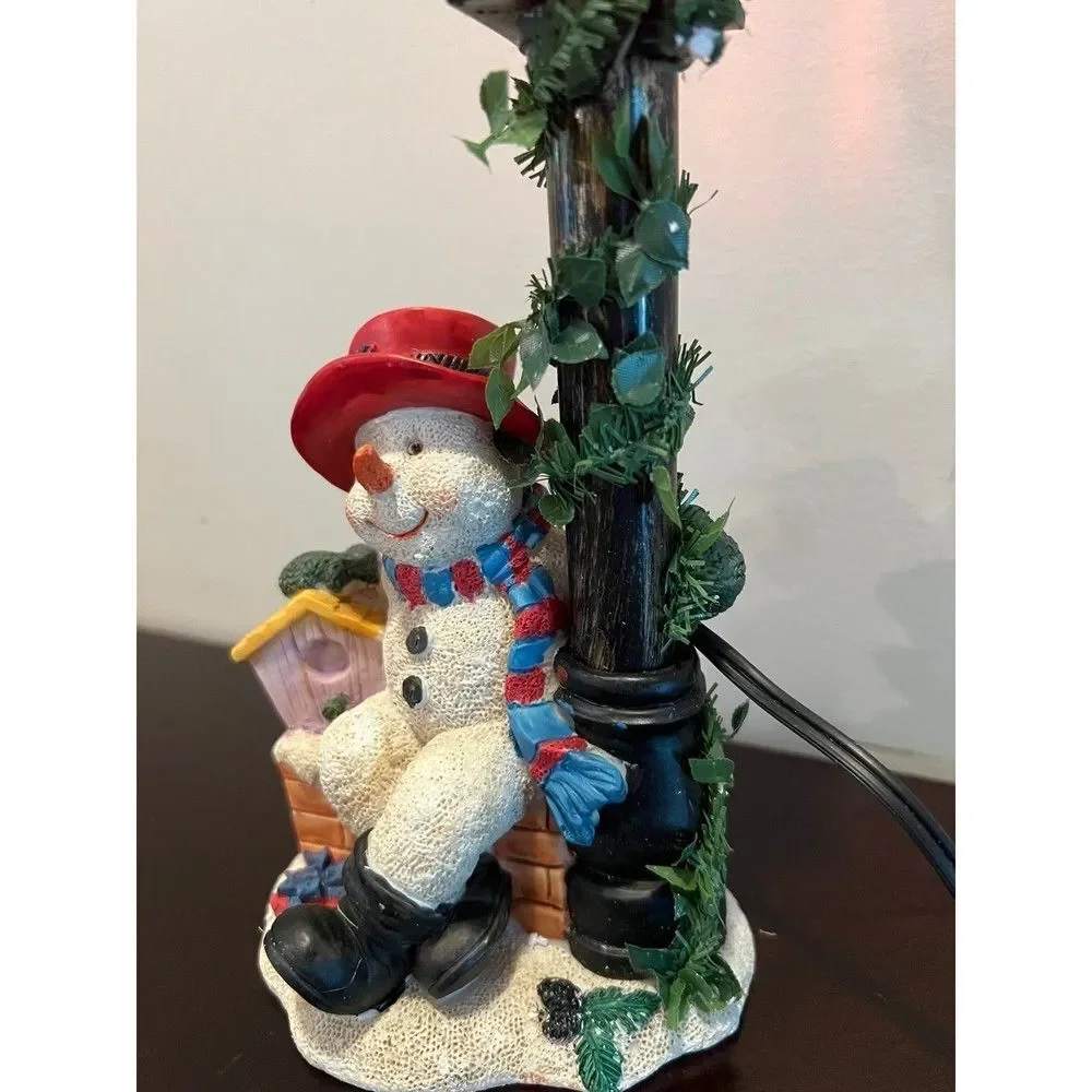 Snowman with flickering street lamp